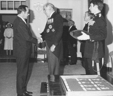 OBE Investiture Ceremony, 1979.  <br/>Malcolm Lyon with the Governor General, Sir Zelman Cowan.